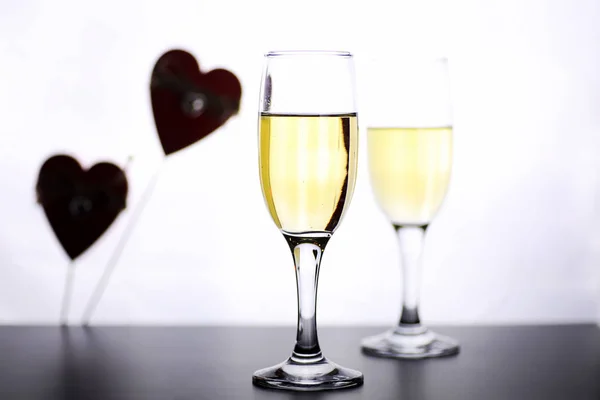 Glass of white wine on a table on white background isolate — Stock Photo, Image