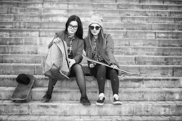 Una giovane hipster sta cavalcando uno skateboard. Ragazze amiche f — Foto Stock