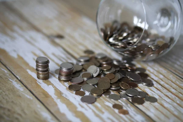 Accumulated coins stacked in glass jars — Stock Photo, Image