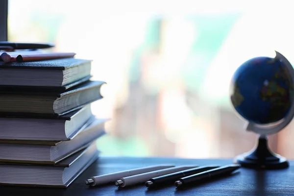 A stack of textbooks on the windowsill — Stock Photo, Image