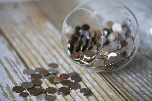 Accumulated coins stacked in glass jars — Stock Photo, Image