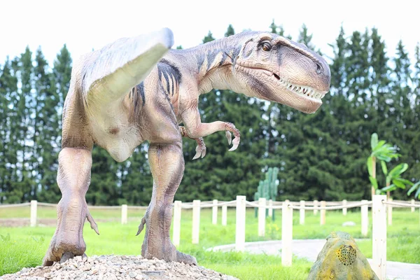 Park of dinosaurs. A dinosaur on the background of nature. Toy d — Stock Photo, Image