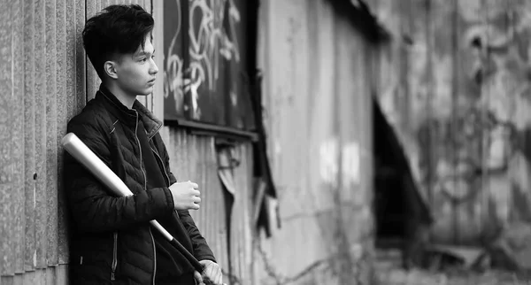 Black White photo of Asian young man outdoors posing