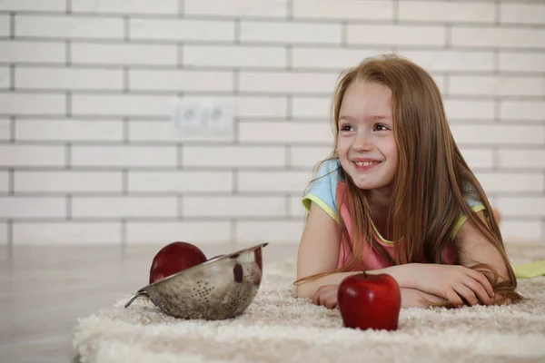 stock image little girl lies on the floor