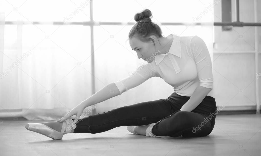Young ballet dancer on a warm-up. The ballerina is preparing to 