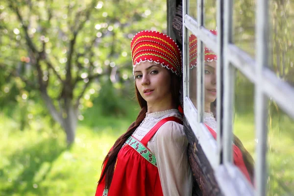 Szláv nő a hagyományos ruha fából készült fal — Stock Fotó