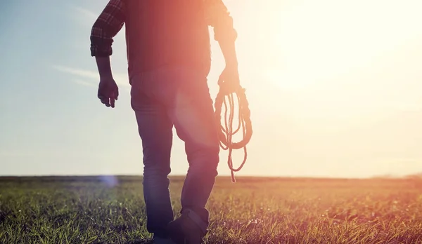 Człowiek kowbojski kapelusz i loso w polu. Amerykański rolnik w f — Zdjęcie stockowe