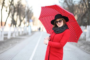 Güzel kız şehirde bir şemsiye ile bir yolda