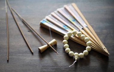 Beads and Incense on wooden table clipart