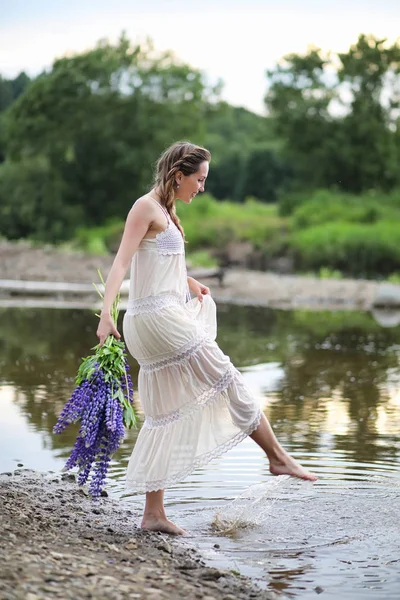 Girl with a bouquet of blue flowers — Stock Photo, Image