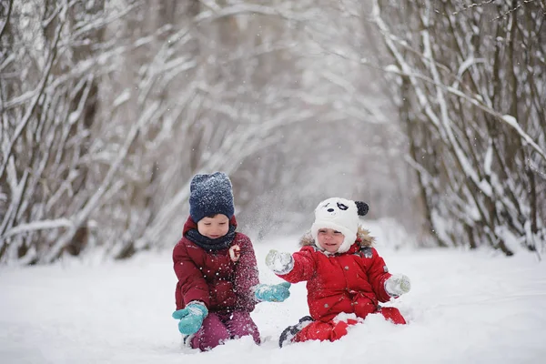Çocuklu genç aile kış parkta yürüyüş. Winte — Stok fotoğraf