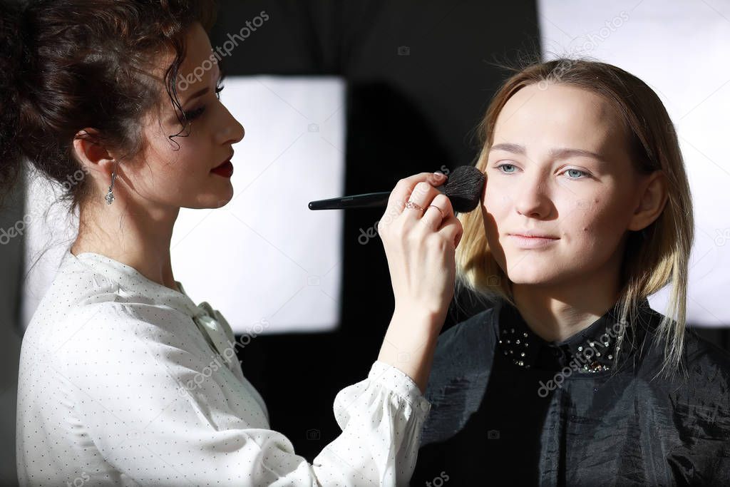 Young girl with a make-up artist