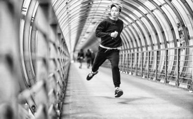 Spor giyimli bir adam açık havada tek renkli fotoğraf çalıştırın