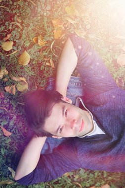 Genç bir adam öğle yemeği zamanında parkta yürür. Bir adam yürüyüşe çıktı. 