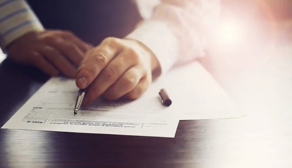 Affärsmöte. En man skriver på ett kontrakt. Manlig hand med penna mak — Stockfoto