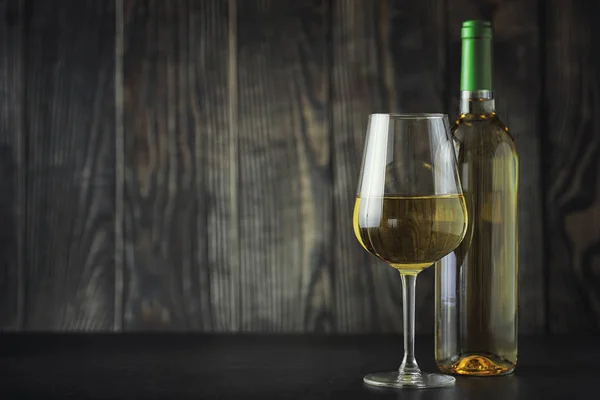 Transparent bottle of white dry wine on the table. White wine gl — Stock Photo, Image