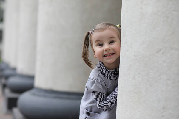 Children on a walk in the spring in the city park. The girl is w