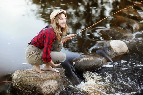 Flicka i höst med ett fiskespö — Stockfoto