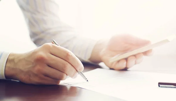 Business meeting. A man signs a contract. Male hand with pen mak — 스톡 사진