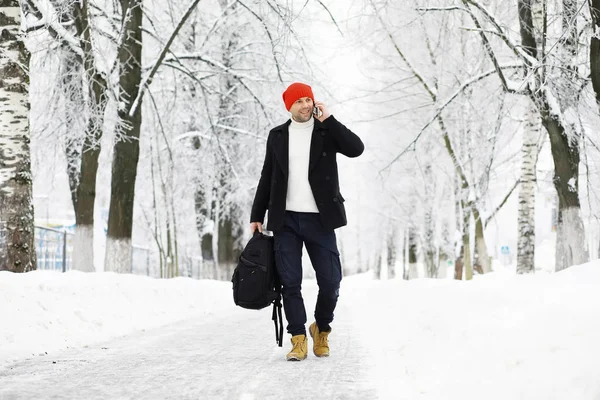 Winter walk with an umbrella.Man in a coat with an umbrella, wal