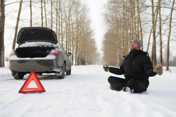 Man and car. Winter walk and car repair. — Stock Photo, Image
