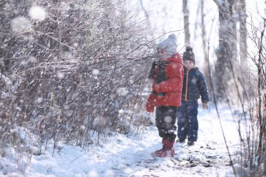 Çocuklar parkta ilk kar yürümek
