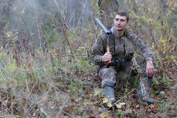 Hombre en camuflaje y con armas en un cinturón forestal en un hun de primavera — Foto de Stock