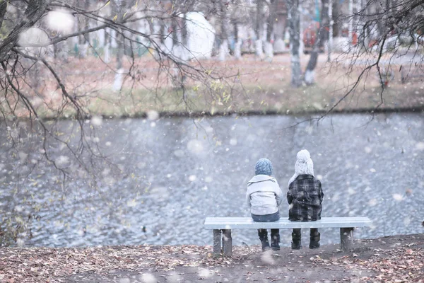 Los niños caminan en el parque primera nieve — Foto de Stock