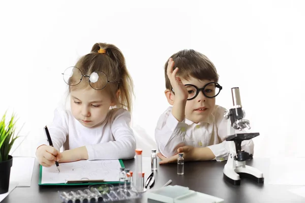 Young scientists chemists. Doctor, laboratory assistant.