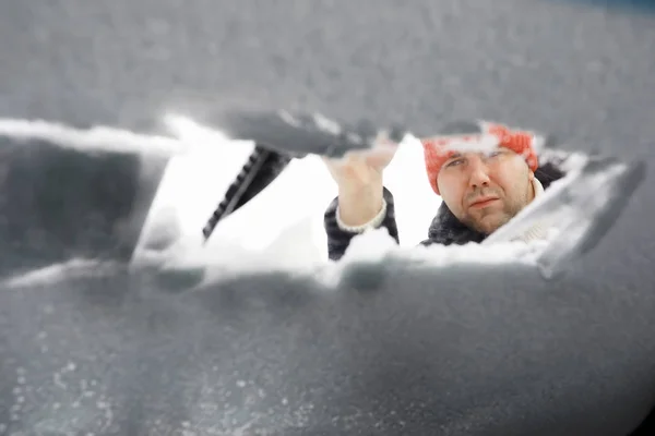 A male driver is standing in front of a car. The owner cleans th — Stock Photo, Image