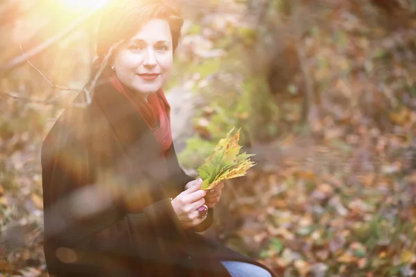 stock image Beautiful woman on a walk in the autumn garden