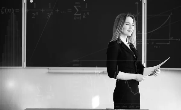 Background with math symbols and teacher in primary school — Stock Photo, Image