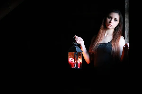 Beautiful girl with red hair with a lantern — Stock Photo, Image