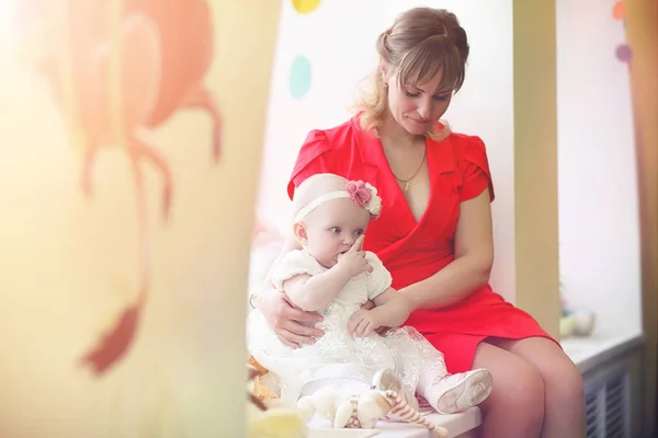 Baby in den Armen des Mädchens. Mutter hält ihr Kind auf dem Arm. h — Stockfoto