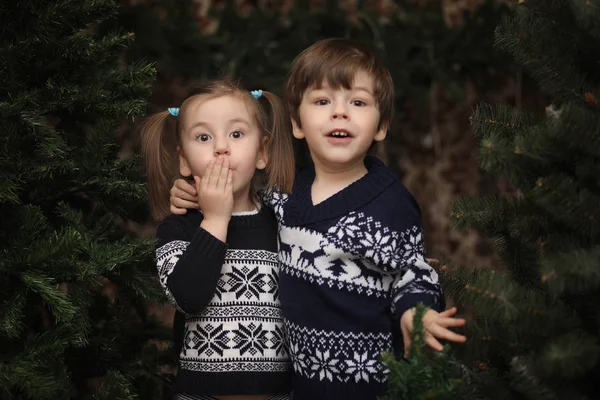 A little child by the New Year tree. Children decorate the Chris — Stock Photo, Image