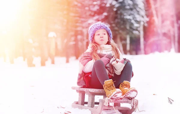 A winter fairy tale, a young mother and her daughter ride a sled — Stock Photo, Image