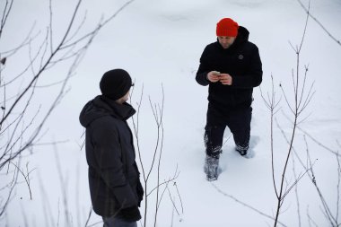 Kışın ormanda bir adam. Sırt çantalı bir turist kışın ormana gider..