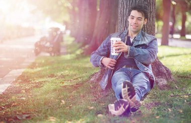 Genç bir adam öğle yemeği zamanında parkta yürür. Bir adam şehirde gezintiye çıktı. Park eden bir öğrenci.