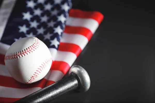 American traditional sports game. Baseball. Concept. Baseball ball and bats on table with american flag.