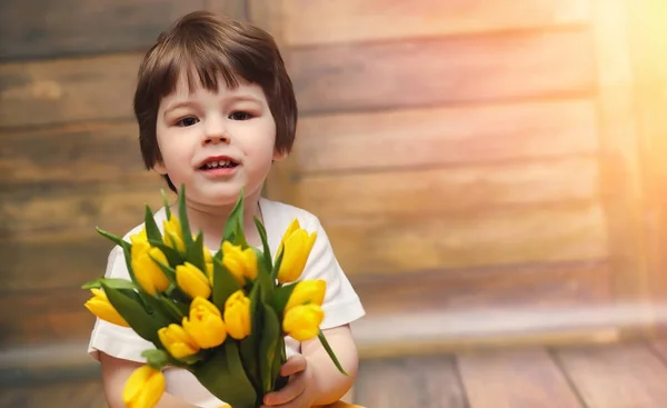 Bir Buket Sarı Laleler Ile Küçük Bir Çocuk Bir Vazoda — Stok fotoğraf