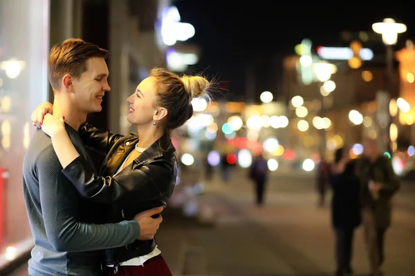 Beautiful couple on a date in a night city outdoor