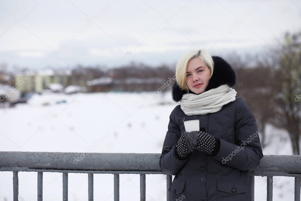 Young beautiful girls on a walk in winter par