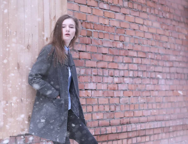 Young girl outdoors in winter. Model girl posing outdoors on a winter day. Festive weekend in the street walking girl