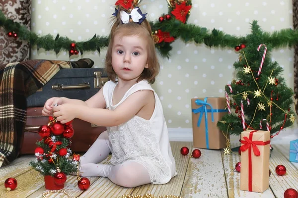 Menina Sentada Frente Uma Árvore Natal Brincando Com Brinquedo — Fotografia de Stock