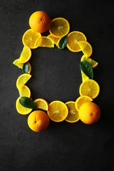 Orange citrus fruit on stone table. Orange background.