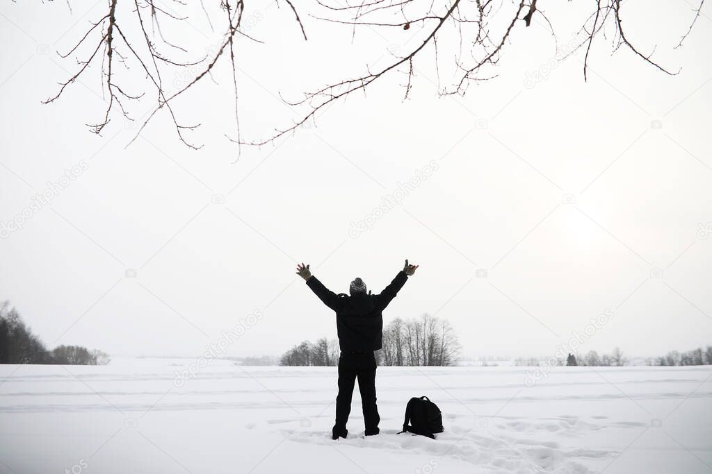 A man on a walk. Winter landscape. Tourist in the winter journey.