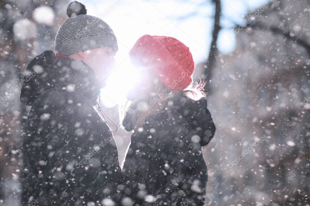 Young couple walking through the winter cit