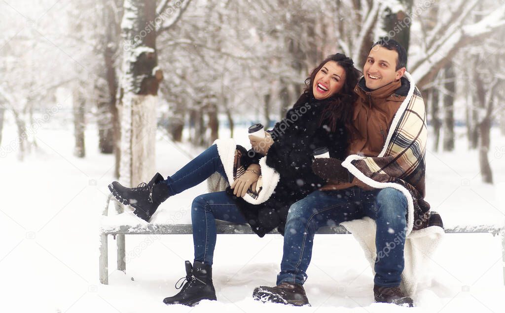 Young couple during date in snowy winter park