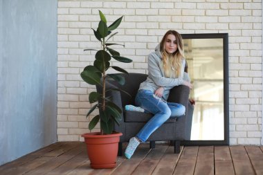 Genç bir kız öğrenci rahat bir odada dinleniyor.