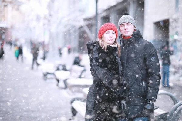 Young couple walking through the winter cit